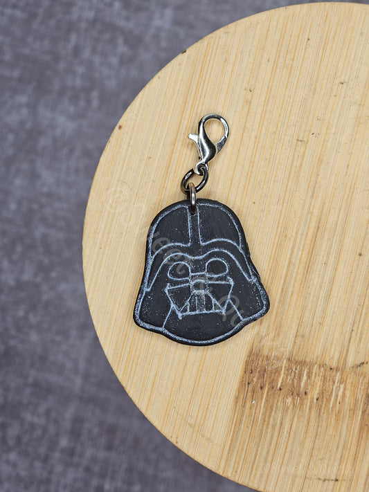 Darth Vader keychain on a wooden surface with a gray background