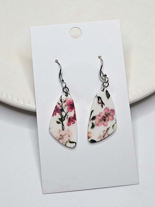 Floral teardrop earrings on a white card with a light background