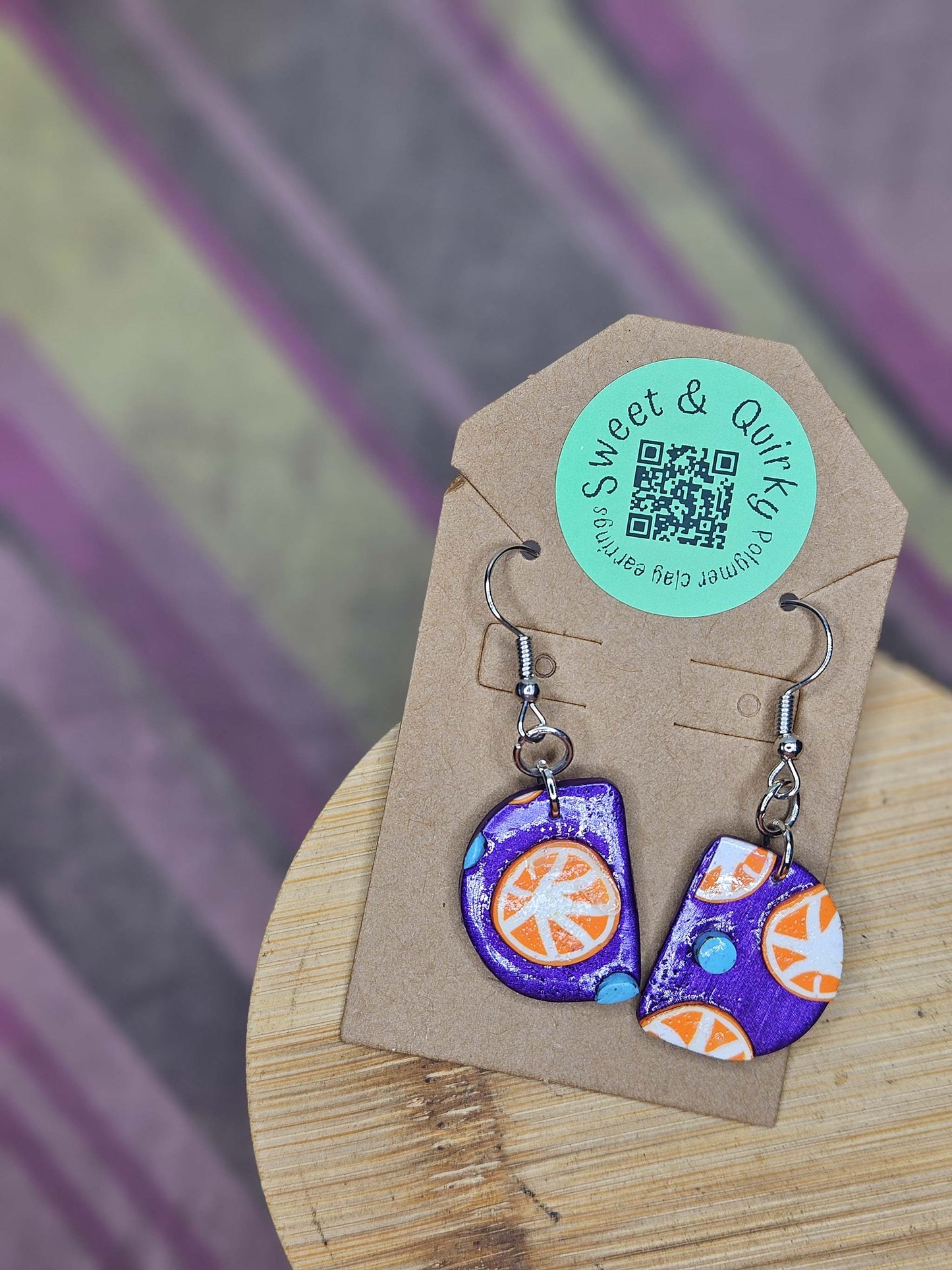 Colorful earrings on a cardboard backing with a 'Sweet & Quick' label.