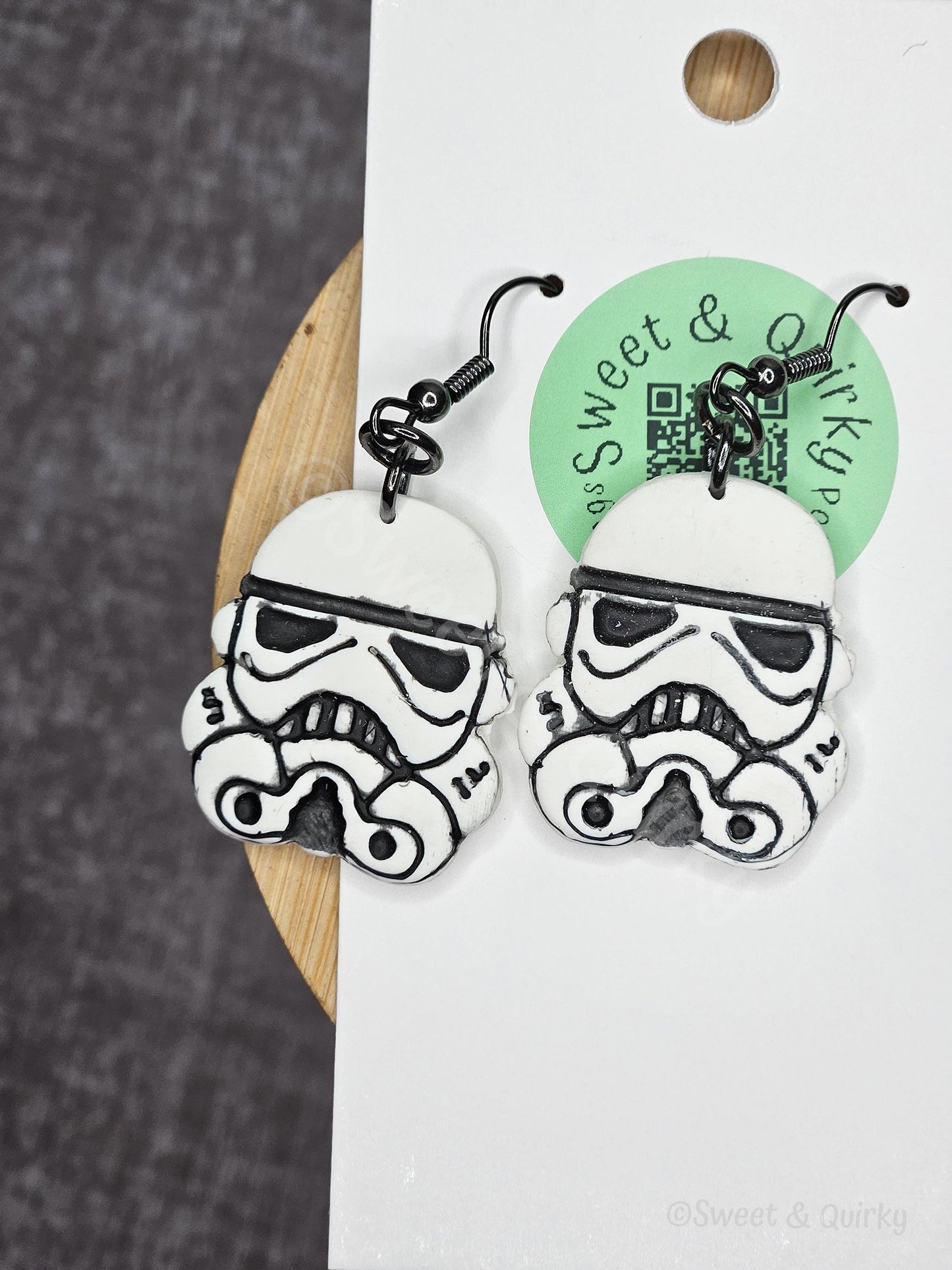 Stormtrooper earrings on a wooden and white background with 'Sweet & Co' label.