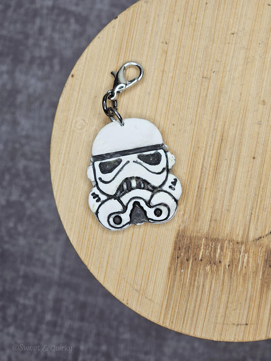 Star Wars Stormtrooper helmet charm on a wooden surface