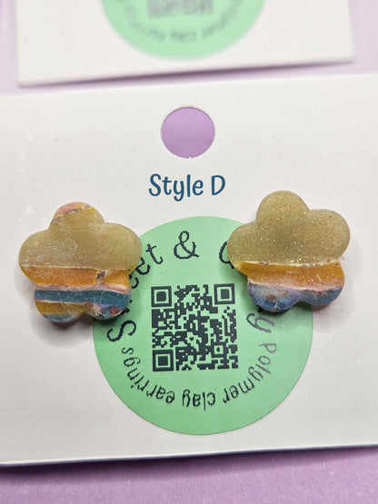 Butterfly-shaped earrings on a card with a QR code and brand name.