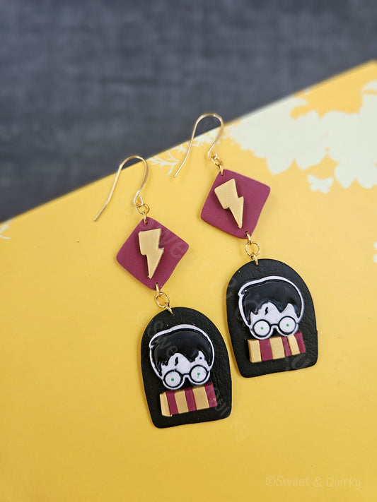 Pair of earrings with Harry Potter design on a yellow background