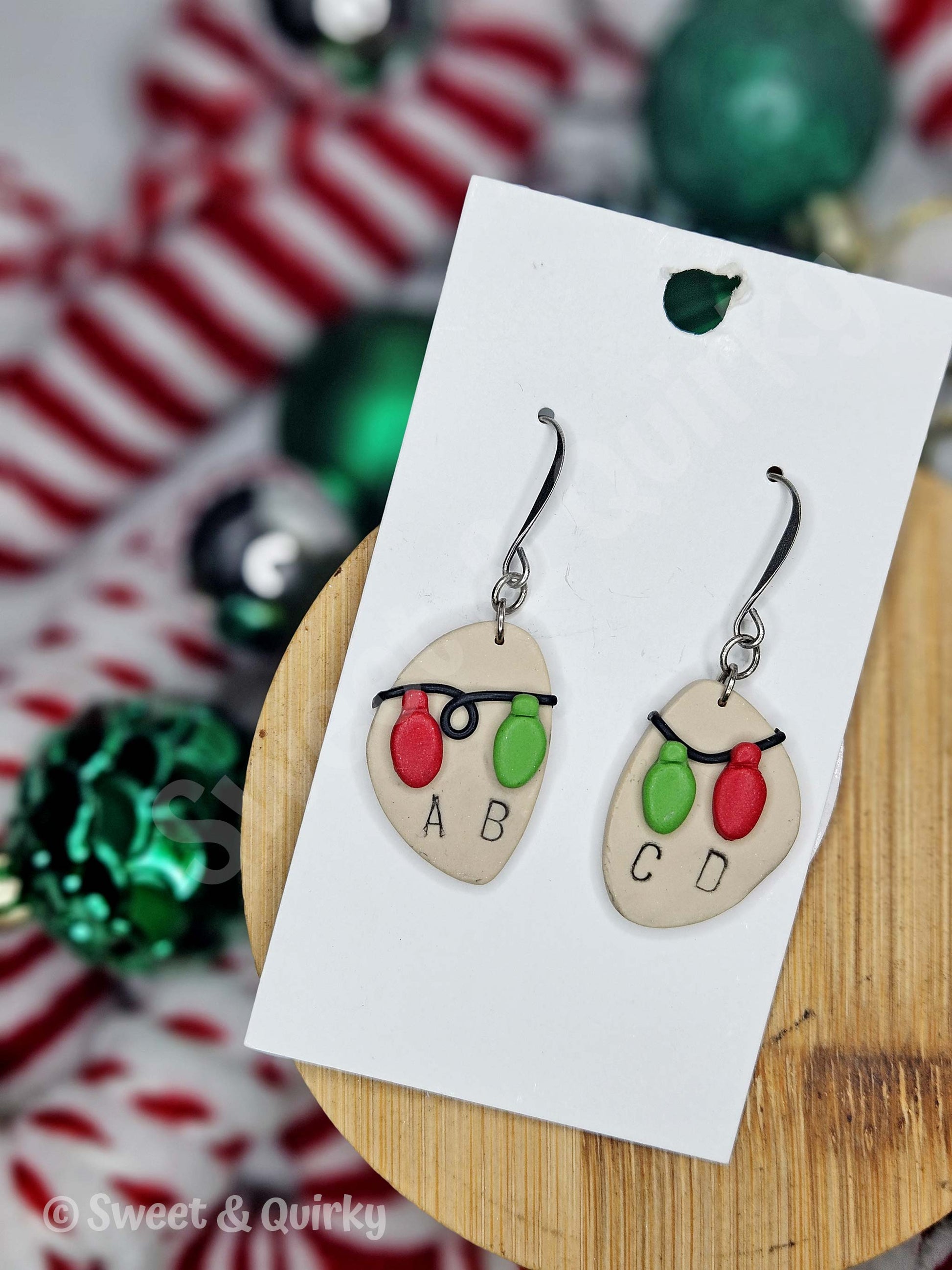 Christmas-themed earrings on a card with festive background